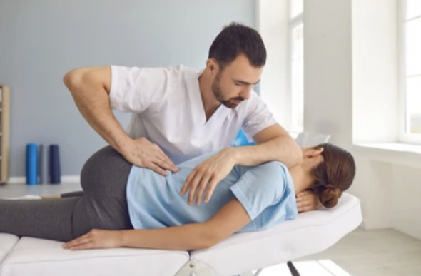 chiropractor performing a manipulation on a patient